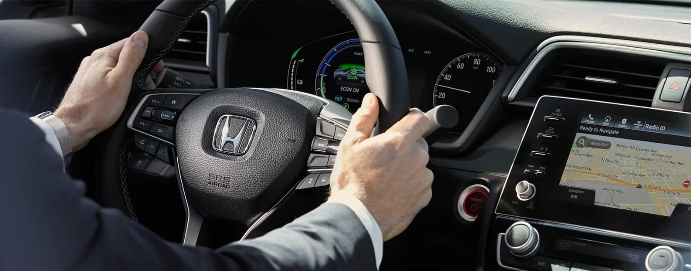 Person sterring a 2022 Honda Insight Touring