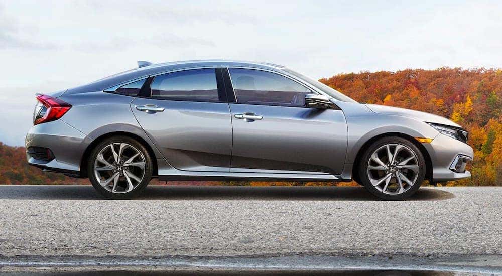 Silver 2019 Honda Civic Sedan Touring parked on a road in fall.