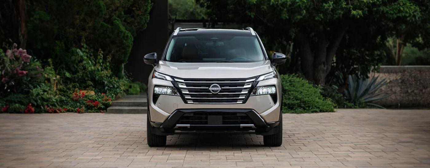 Silver 2025 Nissan Rogue Platinum parked on cobblestones