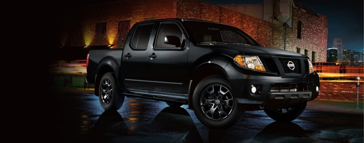 Black 2018 Nissan Frontier Midnight Edition parked on a city street