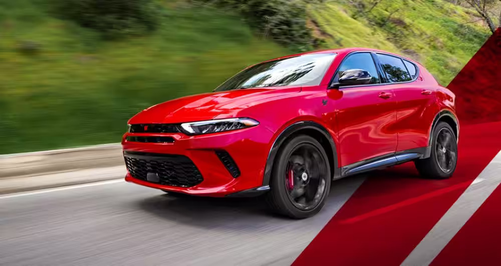 A red car driving along a road.