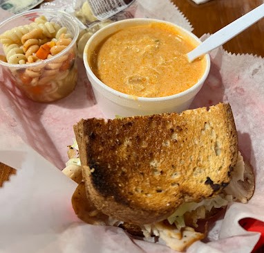 cubano sandwich with a side of soup and potato salad from The Village Corner Deli