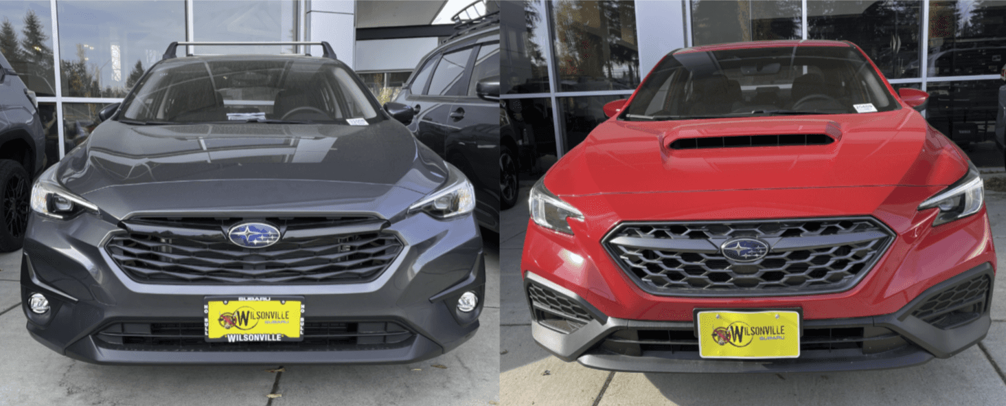 Gray Subaru Impreza and red Subaru WRX parked side by side in the showroom