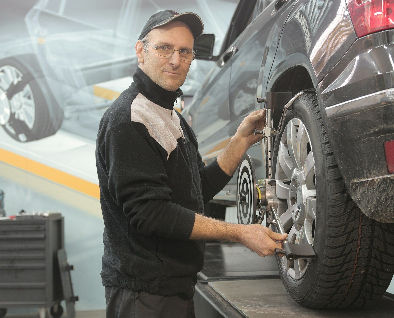 Technician servicing a vehicle in a clean service bay