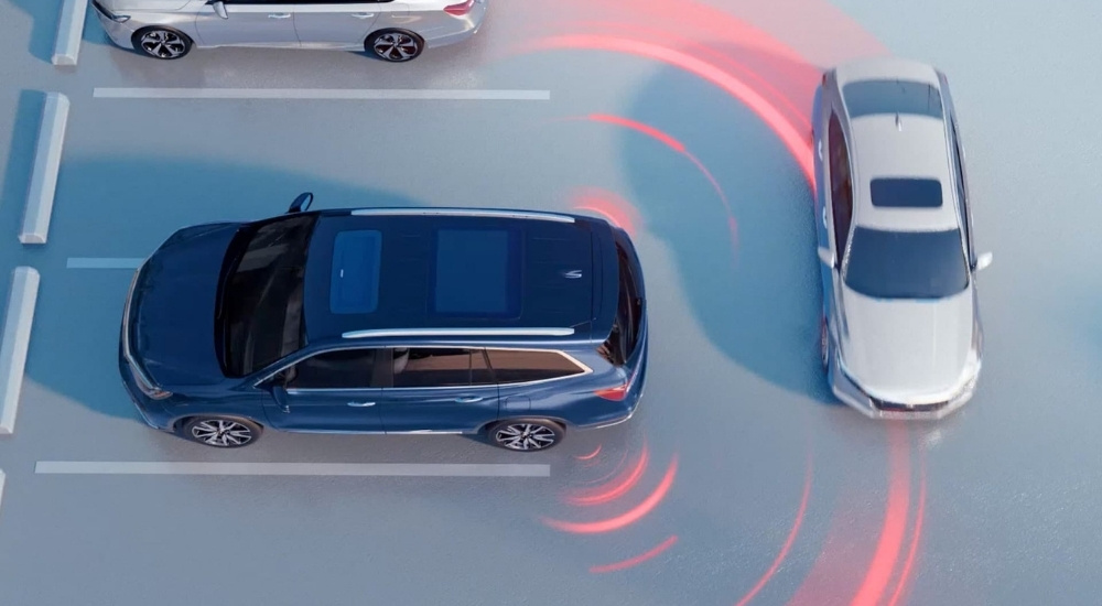 Blue 2020 Honda Pilot is shown reversing after looking at used cars for sale near Bloomfield