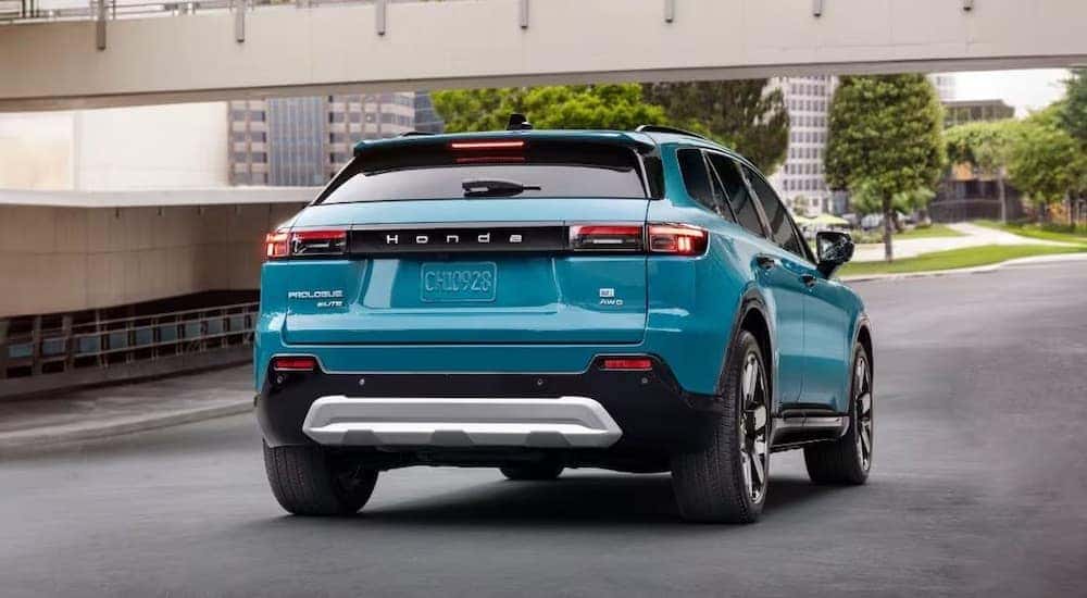 A blue 2024 Honda Prologue is shown from the rear.