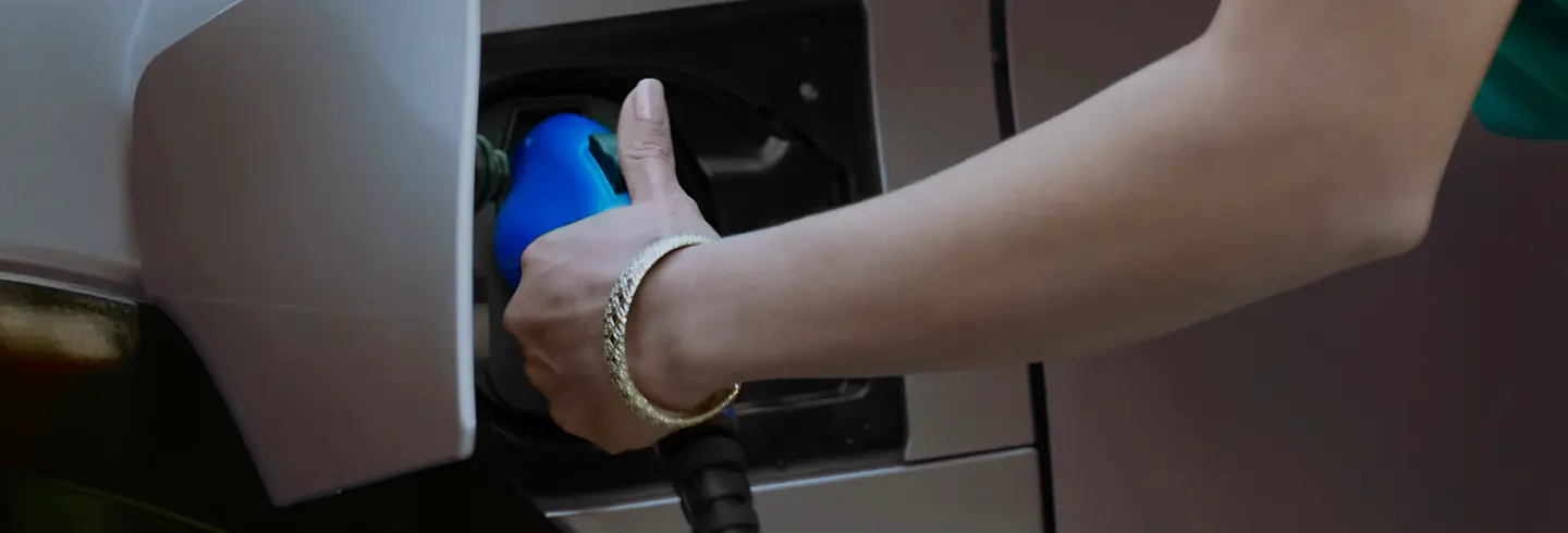 A close up exterior shot of an RZ being plugged in to charge..