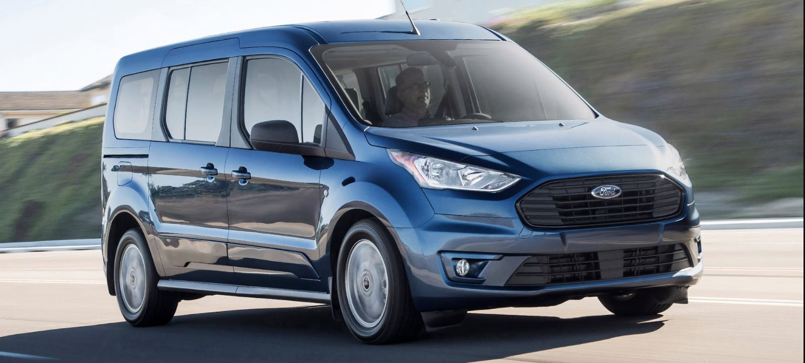 blue/gray 2023 Ford Transit Connect cruising on the highway