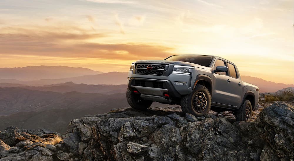 Silver 2024 Nissan Frontier parked off-road on a cliff.