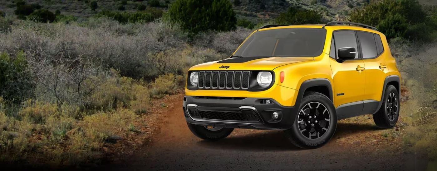 A yellow 2023 Jeep Renegade is shown parked off-road after leaving a Jeep dealership near you.