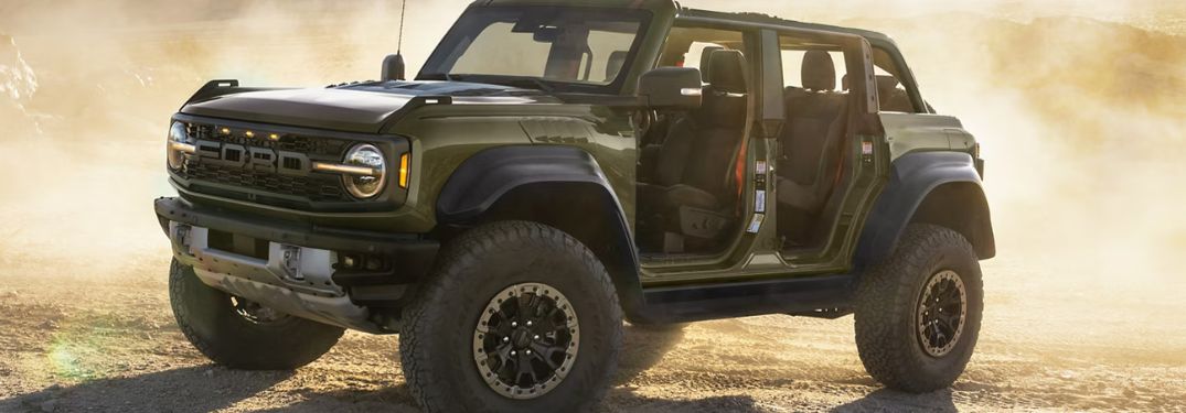 Green 2024 Ford Bronco Raptor in Dust Cloud in Desert