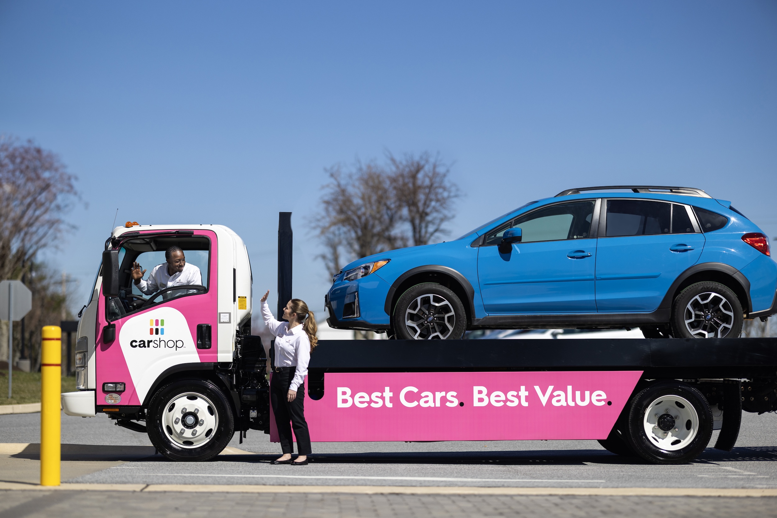 Carshop truck delivering blue car