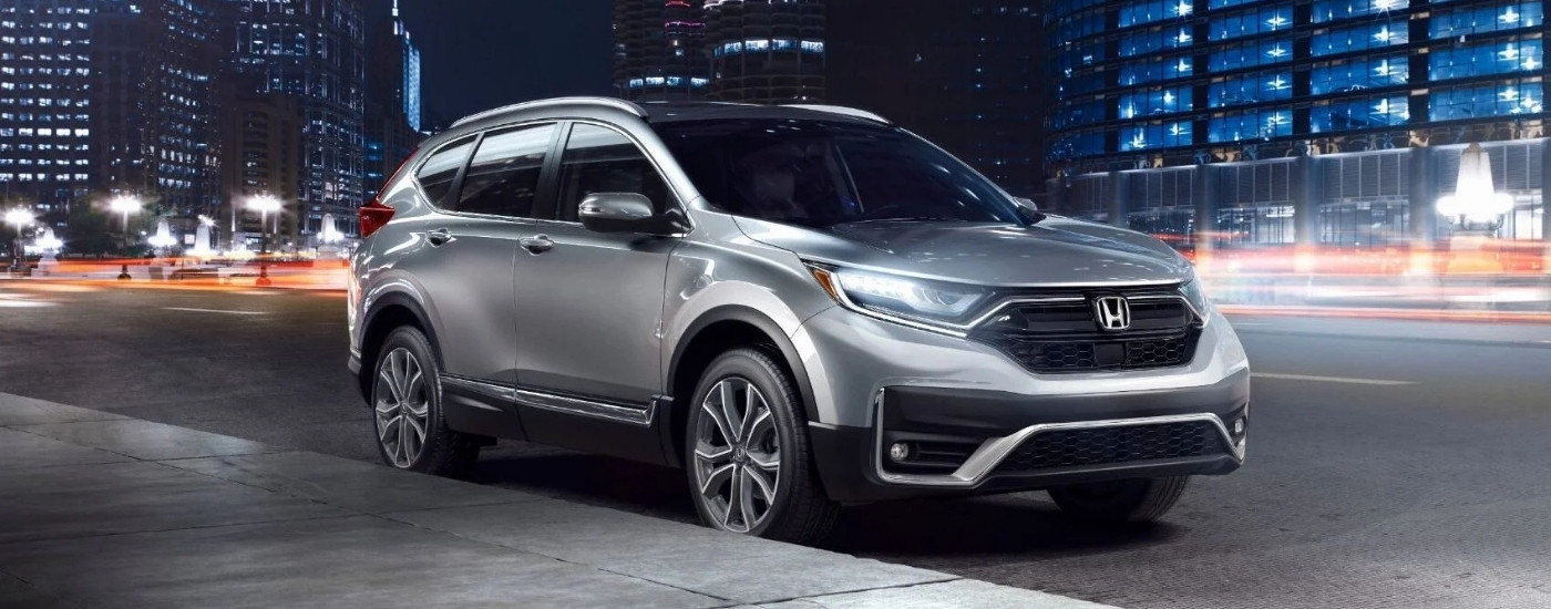 Silver 2021 Honda CR-V Touring parked by a curb.