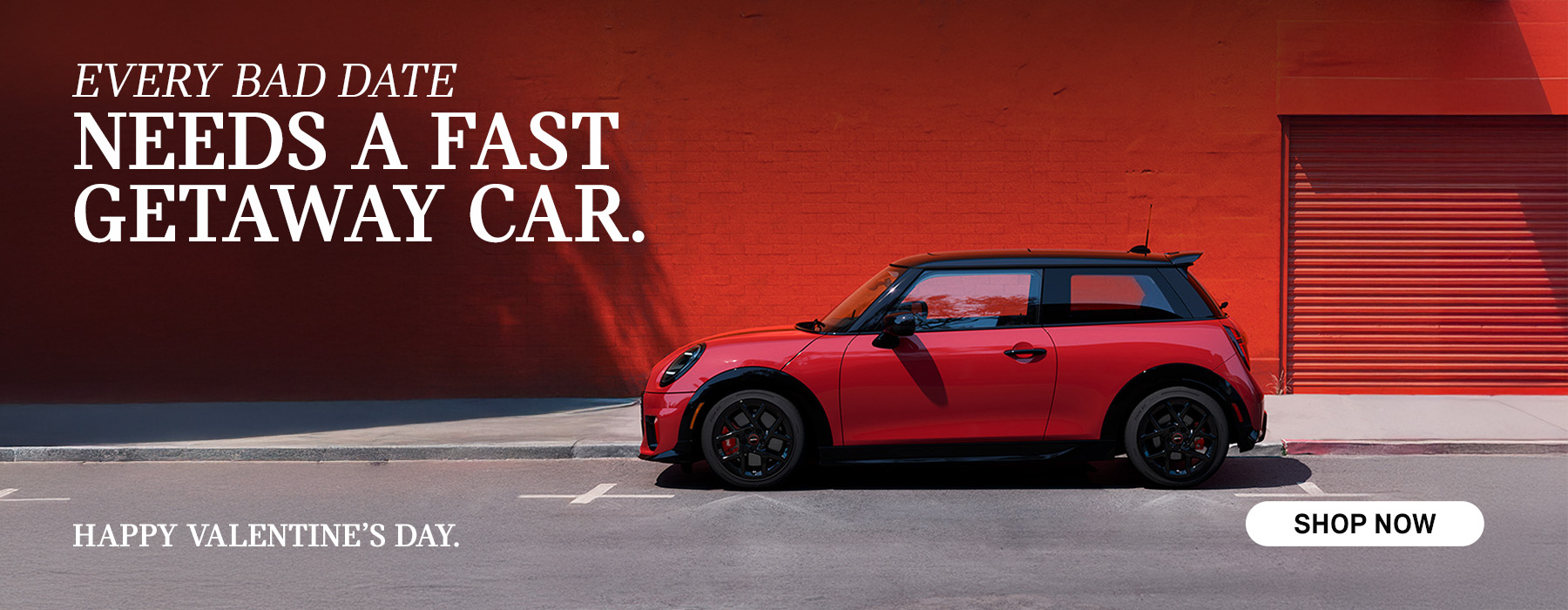 Red MINI 2 Door parked in front of a red wall.