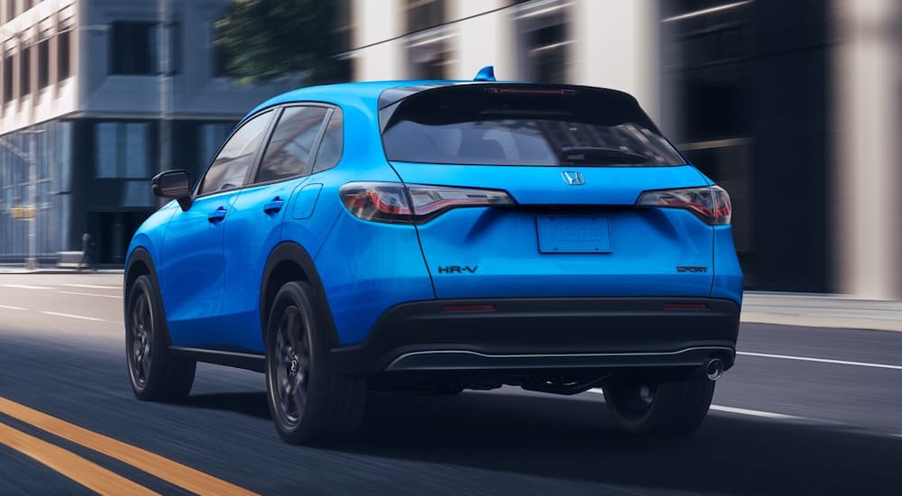 Blue 2026 Honda HR-V Sport driving on a city street