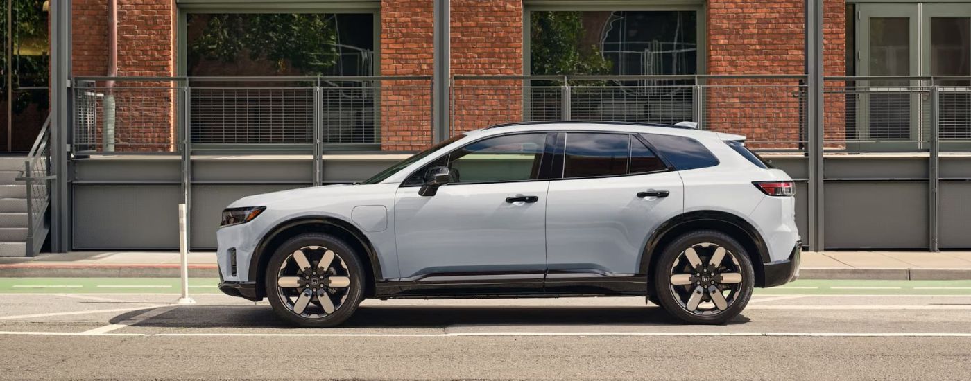 White 2025 Honda Prologue on the side of a city street