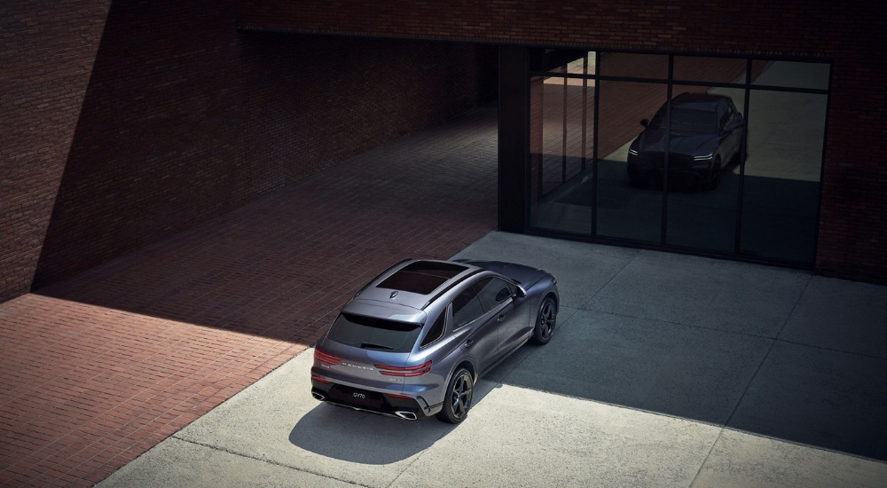 Grey 2026 Genesis GV70 parked in front of a building