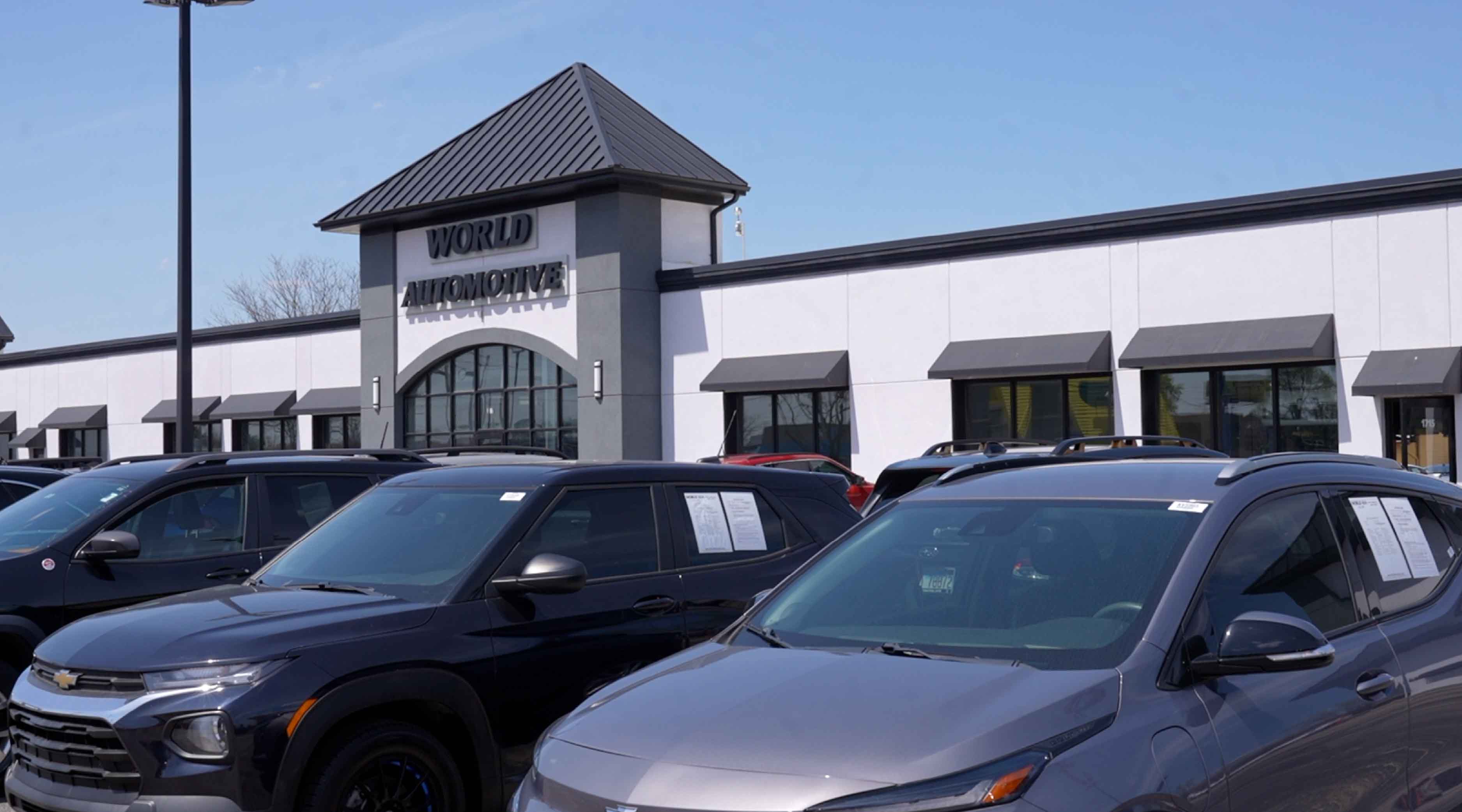 Exeterior of World Automotive Used Car dealership on a sunny day