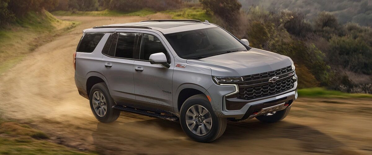 The 2023 Chevrolet Tahoe driving on a dirt road.