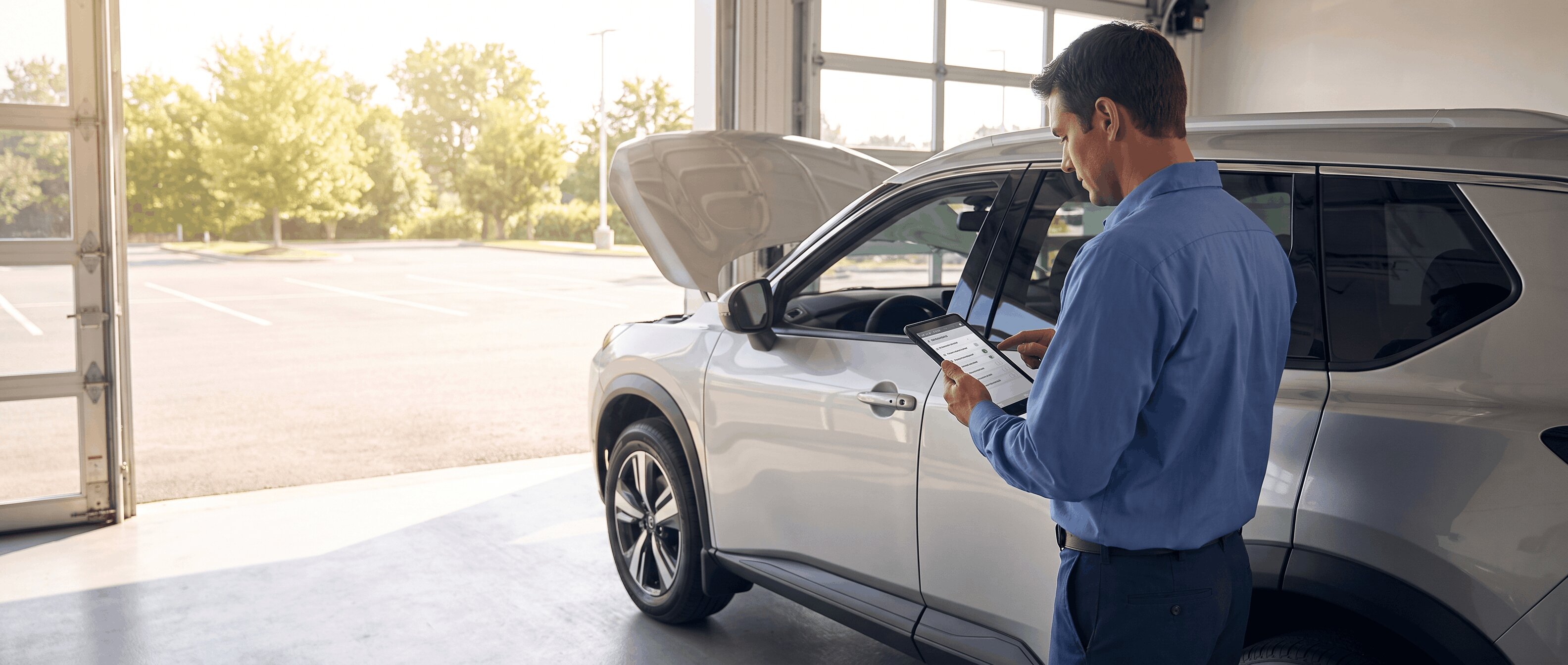 2026 Nissan Rogue in a Roswell dealership service bay during a mid-year maintenance inspection