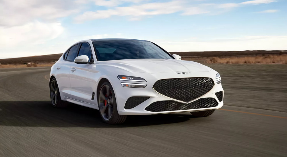 White 2026 Genesis G70 driving on a track