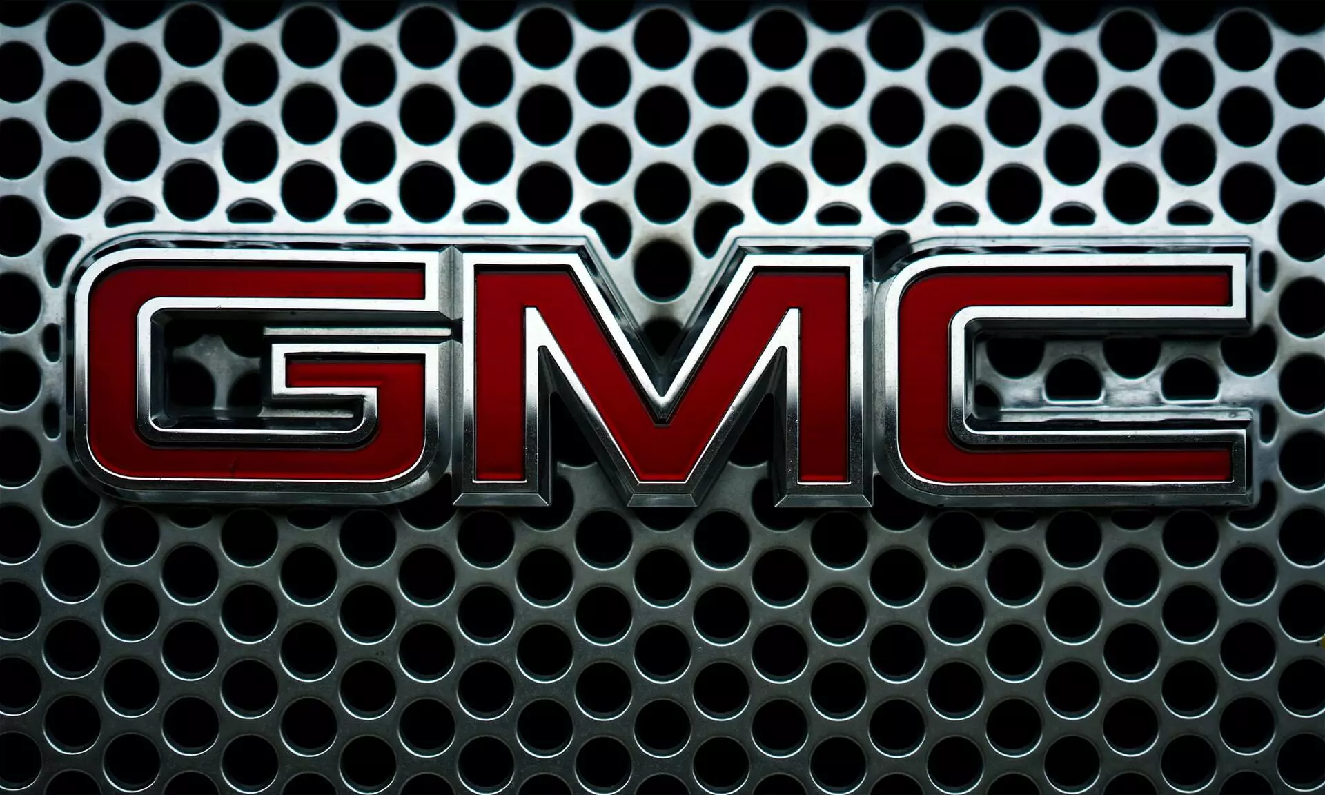 The GMC logo is the focus of the image, the GMC logo is the 3 letters GMC in Red