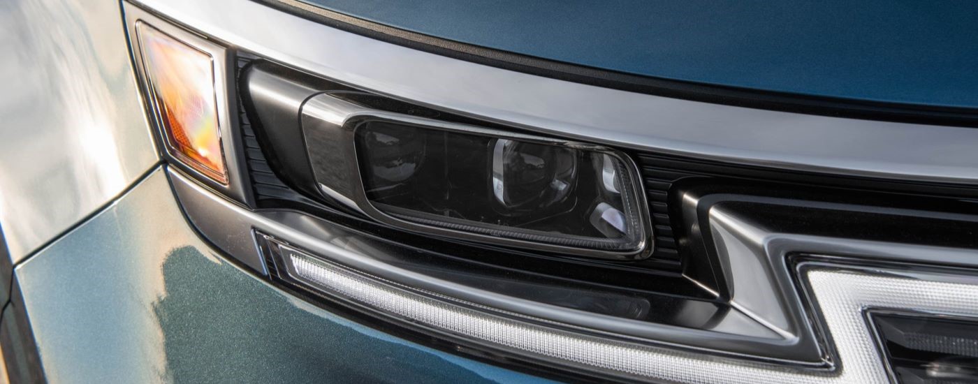 Close up of a headlight on a 2024 Kia Carnival.