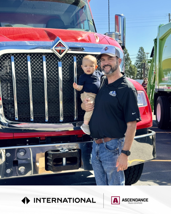 Truck salesperson with red International Heavy-duty truck