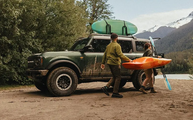 image of ford bronco driving on dirt road