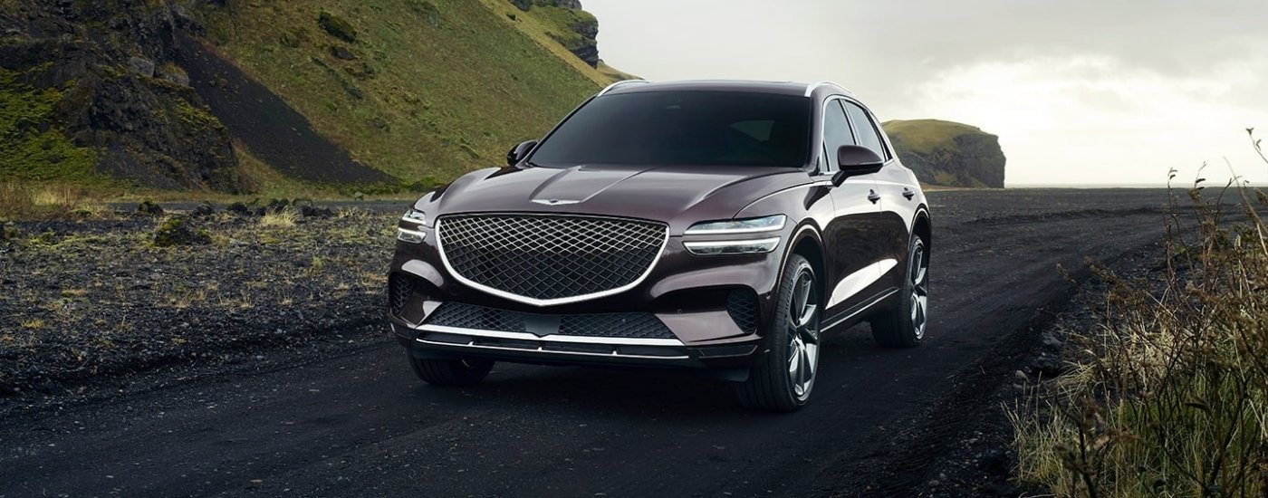 Grey 2022 Genesis GV70 driving on a trail