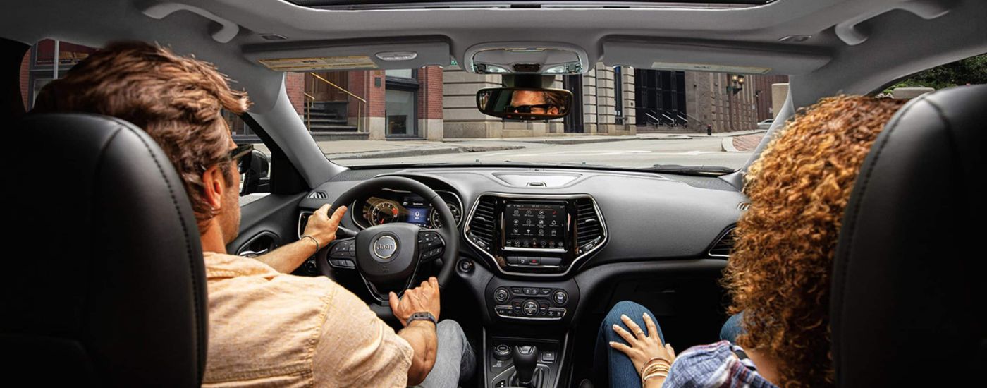 People are shown in a 2023 Jeep Cherokee Altitude Lux.