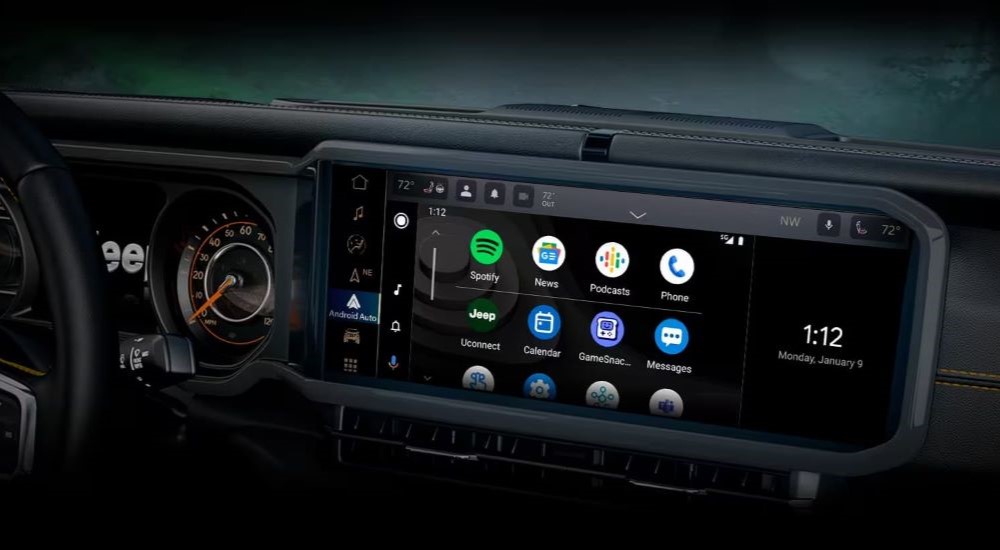 "A close up shows the apps on the infotainment screen in a 2024 Jeep Wrangler