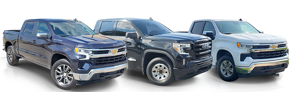 A line of trucks featuring two Chevrolet Silverados, and a GMC Seirra.
