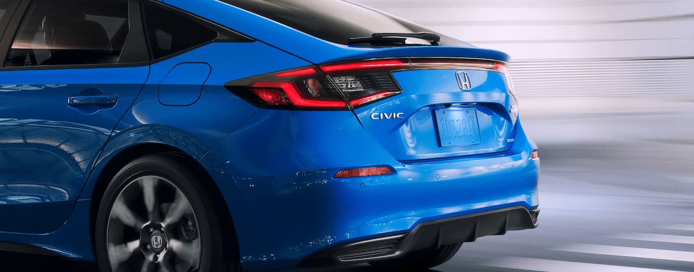 Rear of a blue 2026 Honda Civic Hatchback on a highway
