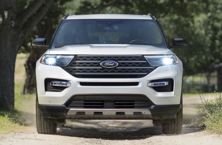 White 2024 Ford Explorer King Ranch Front Exterior on Wooded Road