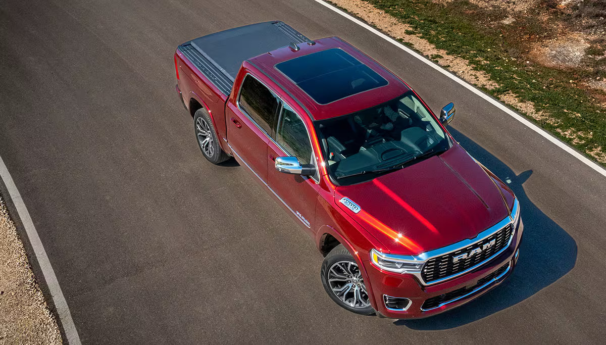 A red 2025 Ram 1500 sitting in the road.