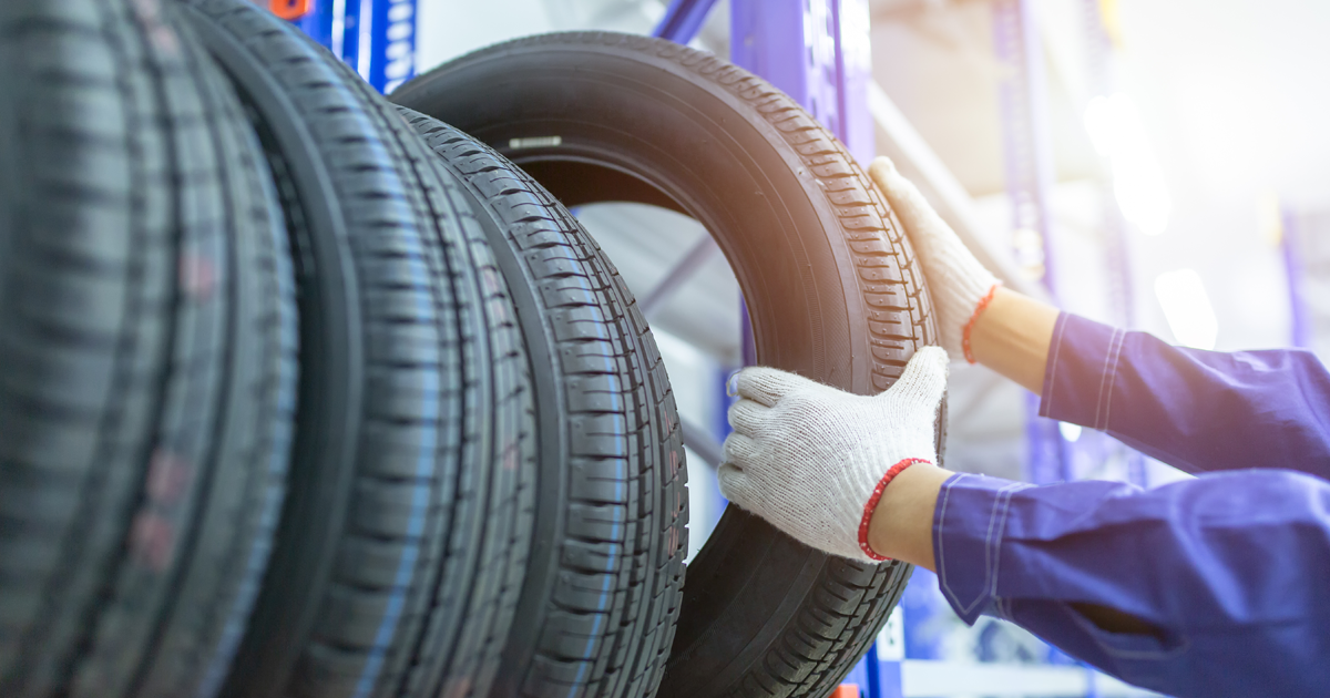 Mechanic pulls tire off a rack