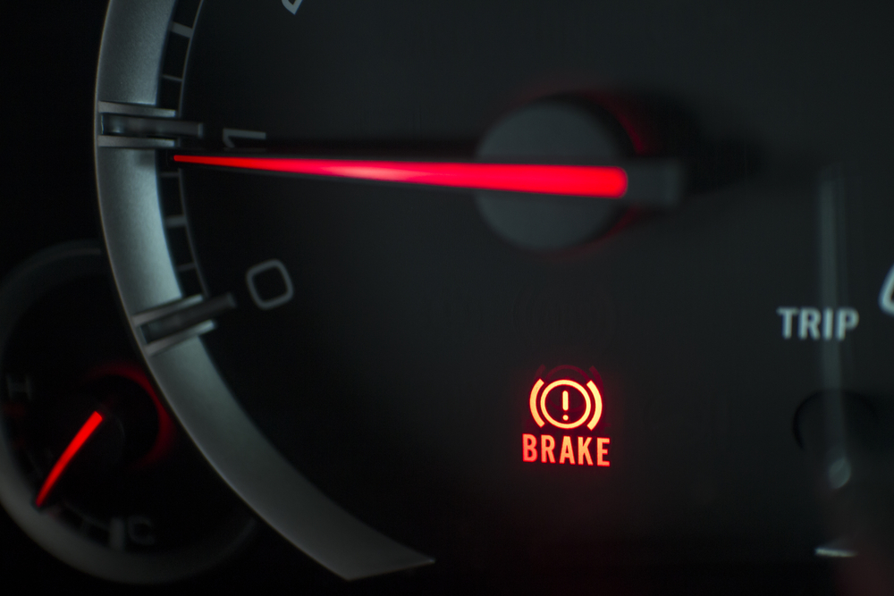 Dashboard displaying a red brake warning light.