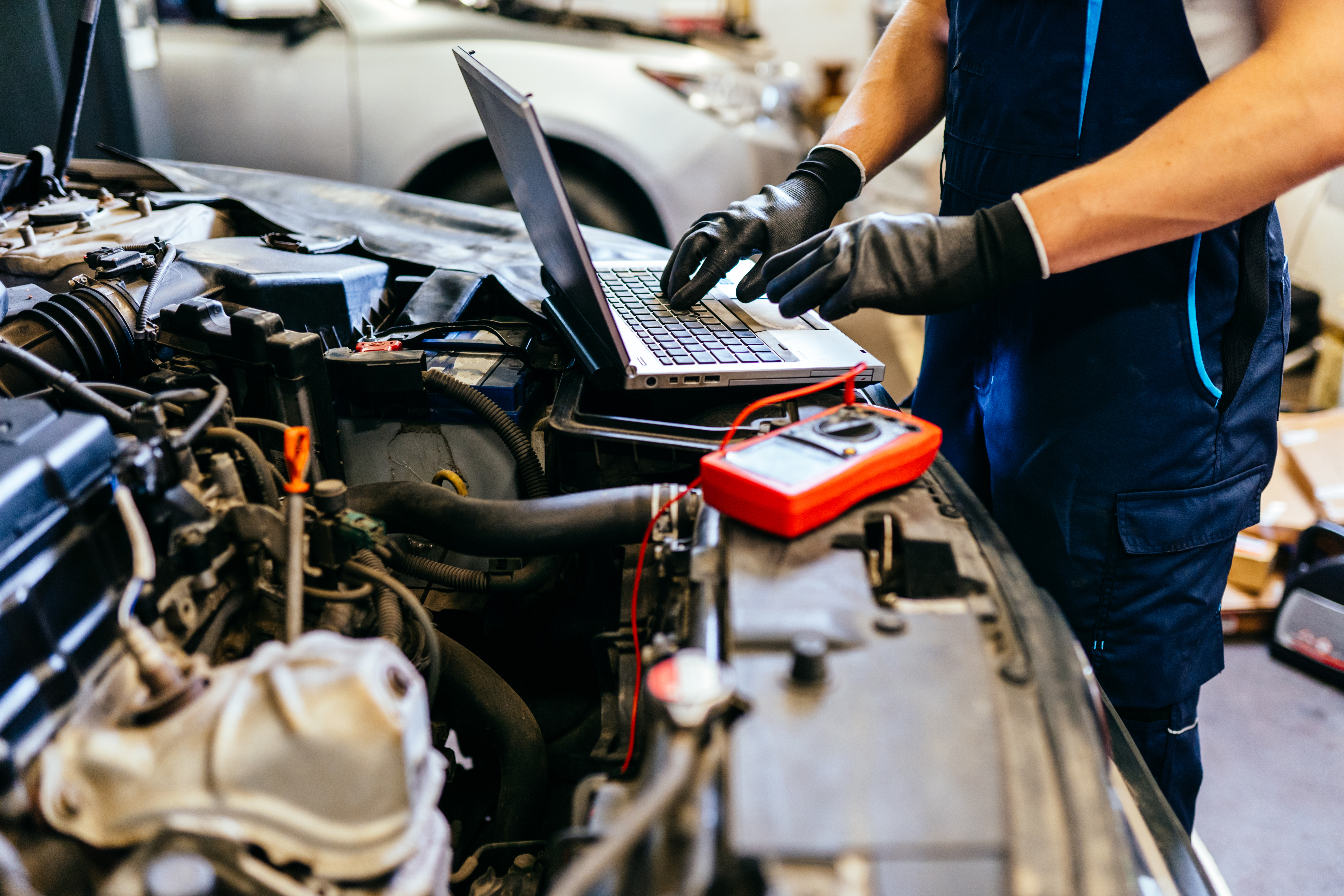 Ford technician using a digital diagnostic scanner to check engine codes near Andover, KS