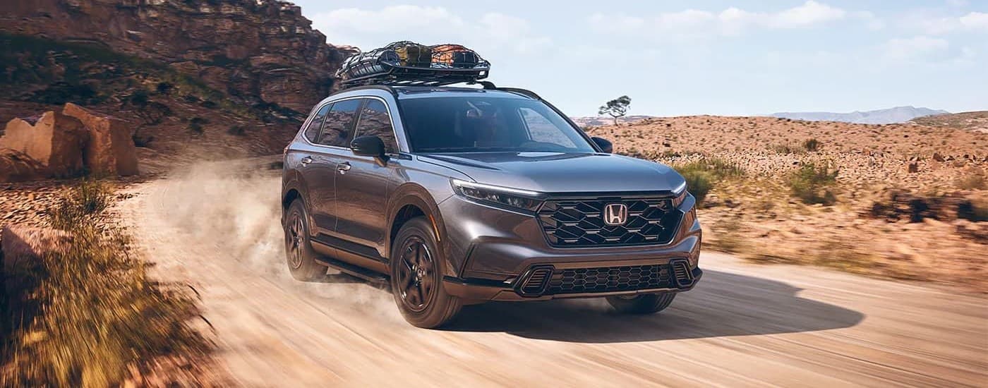 Grey 2024 Honda CR-V driving off-road