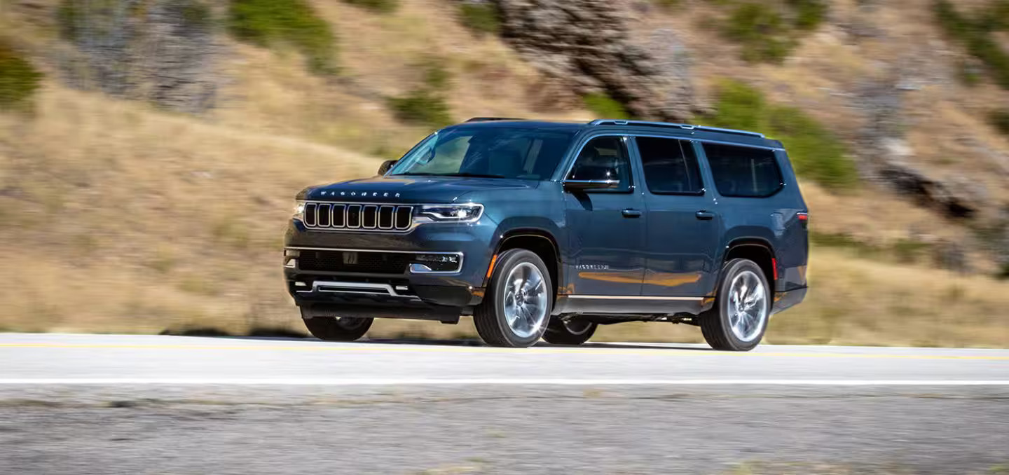 a suv driving down a road.