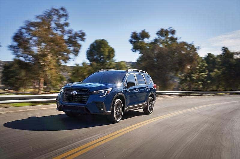 Blue Subaru Forester driving on a winding road