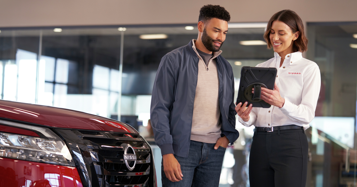 Nissan service advisor speaks to customer about recommended services