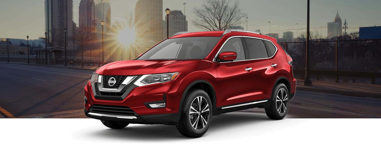 Red 2018 Nissan Rogue crossover on a city street