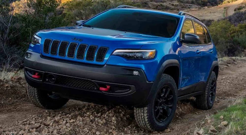 A blue 2020 used Jeep Cherokee driving off-road.
