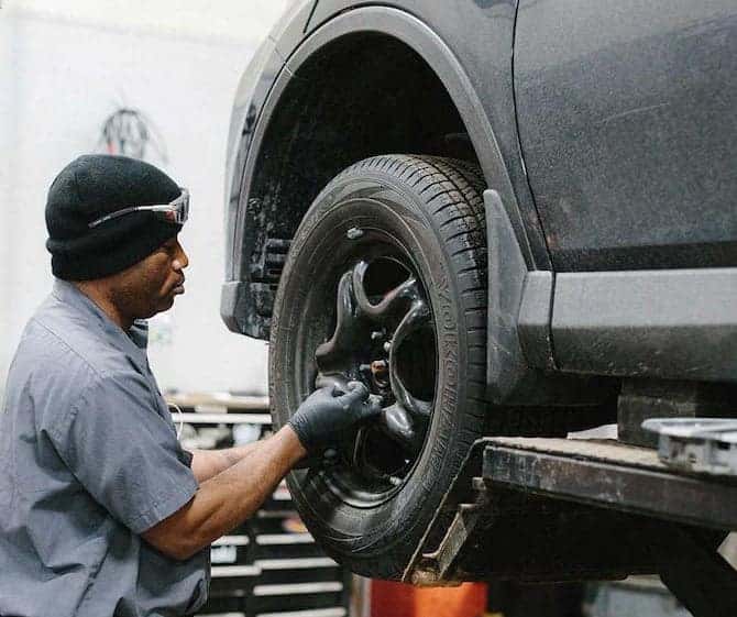 service agent working on tire