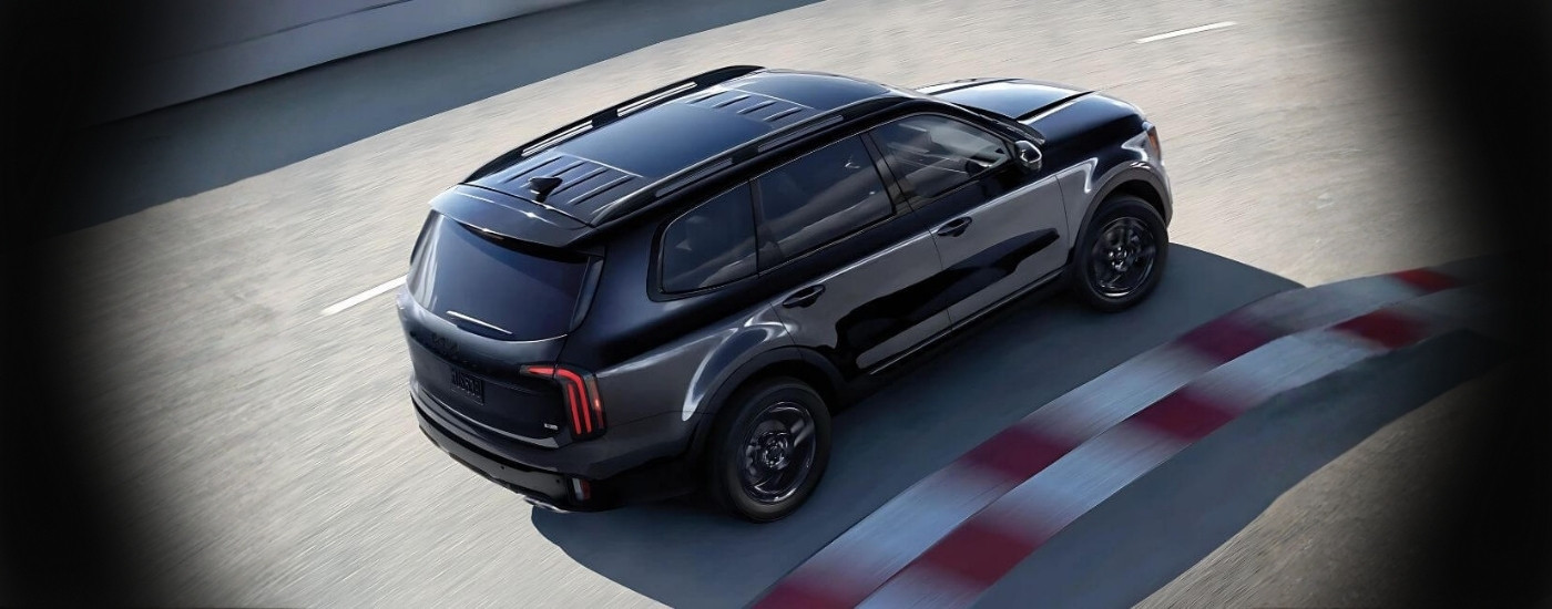 Black 2025 Kia Telluride driving on a track