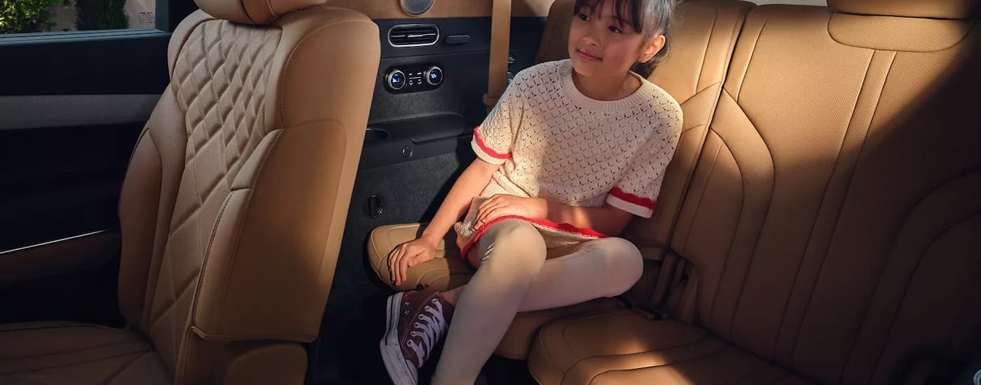 Child sitting in the backseat of a 2025 Genesis GV80