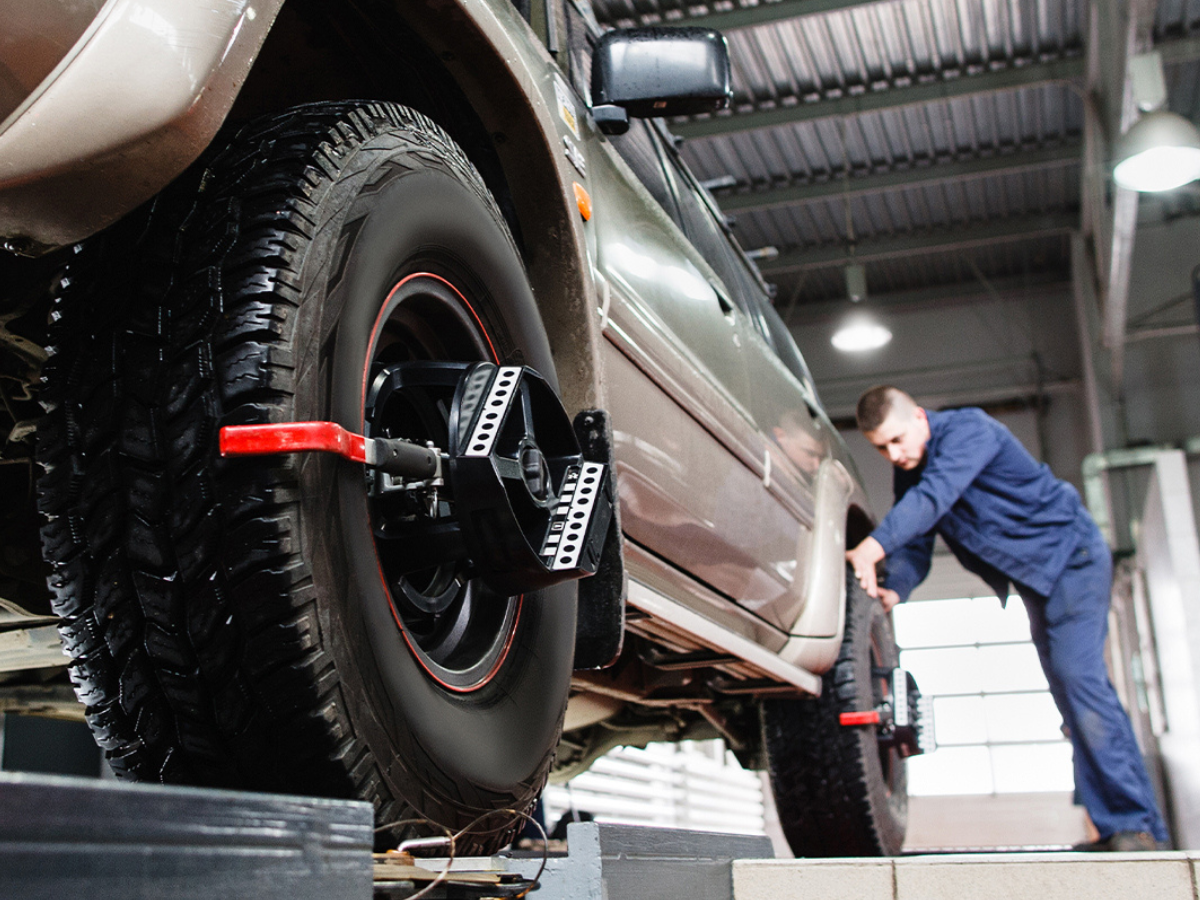 Technician works on a vehicle alignment