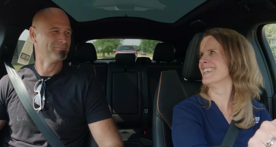 Lakeland Church pastor Josh Amstutz and Kunes Auto Group Director of Marketing, Jen Myers, laughing inside of a 2023 Ford Mustang Mache-E